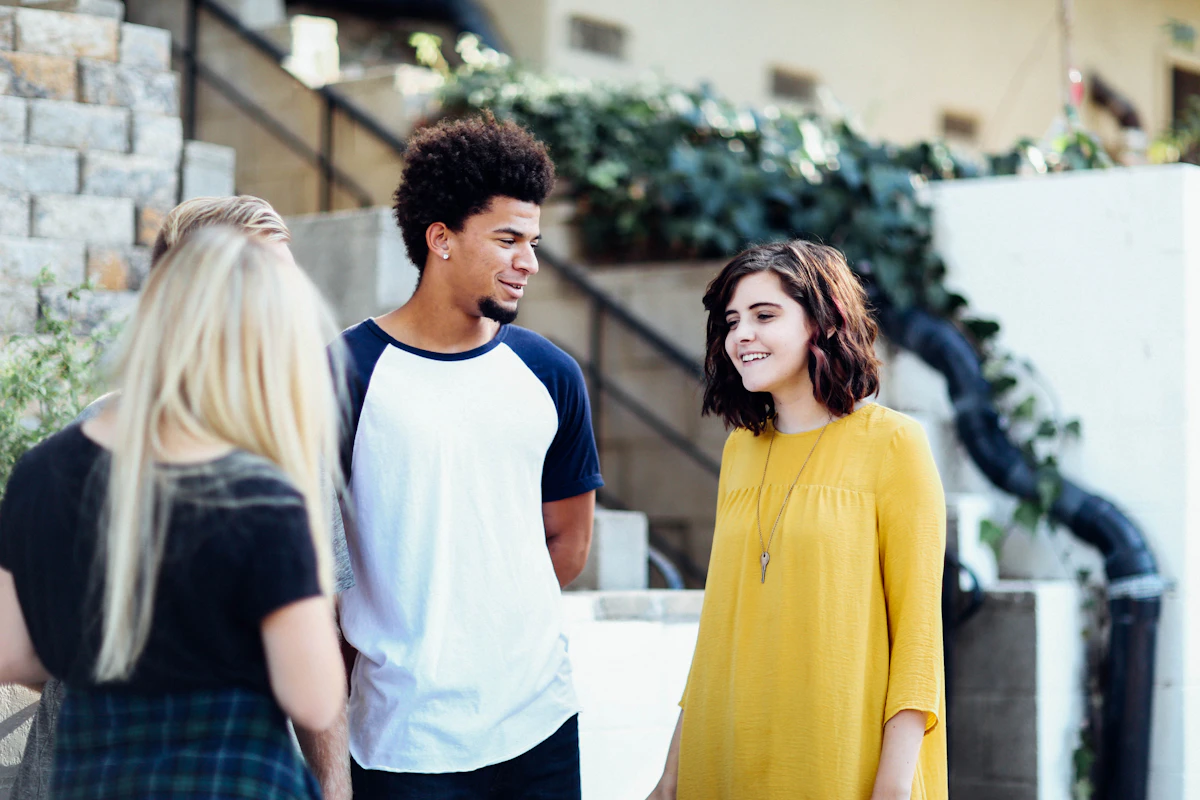Three people talking together outdoors