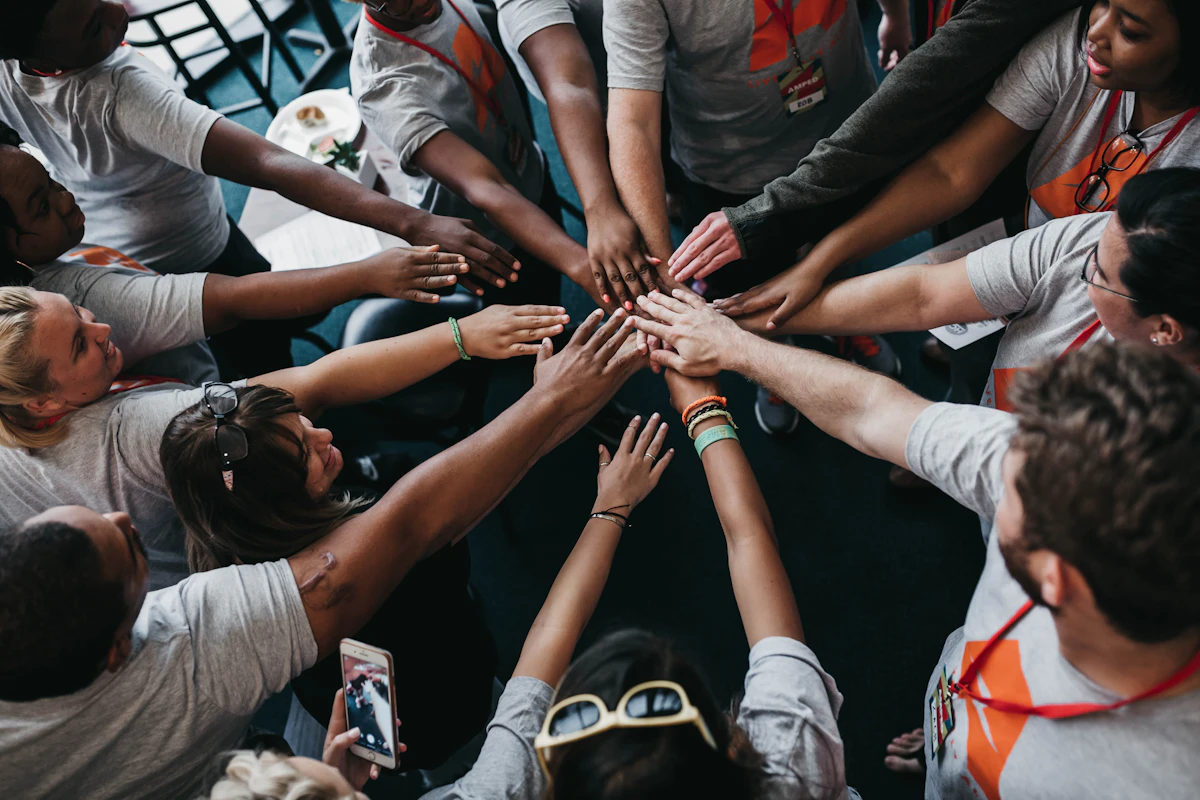 People bringing their hands together during a workshop